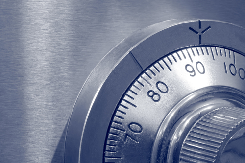 Closeup of combination safe lock in blue duotone.